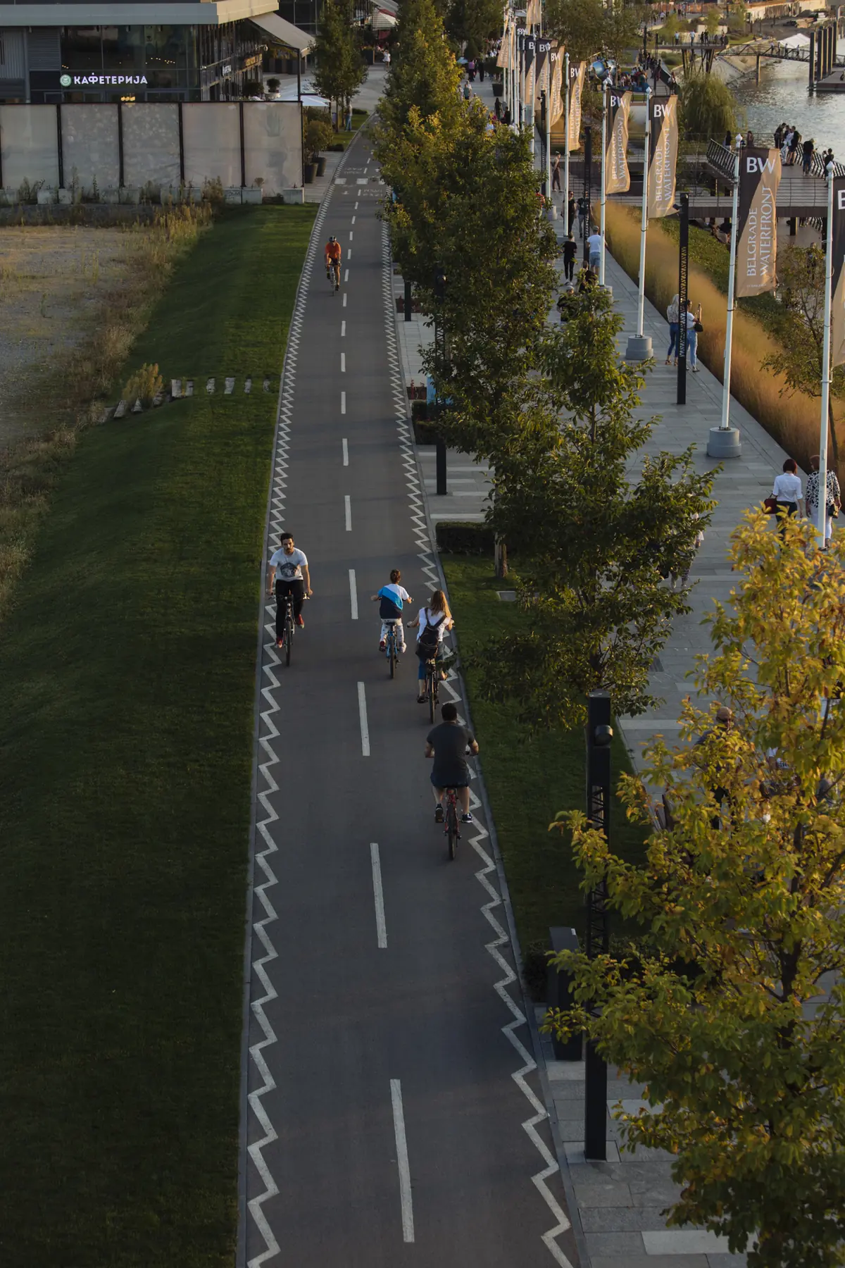 Cyclists and walkers on the riverside path from above